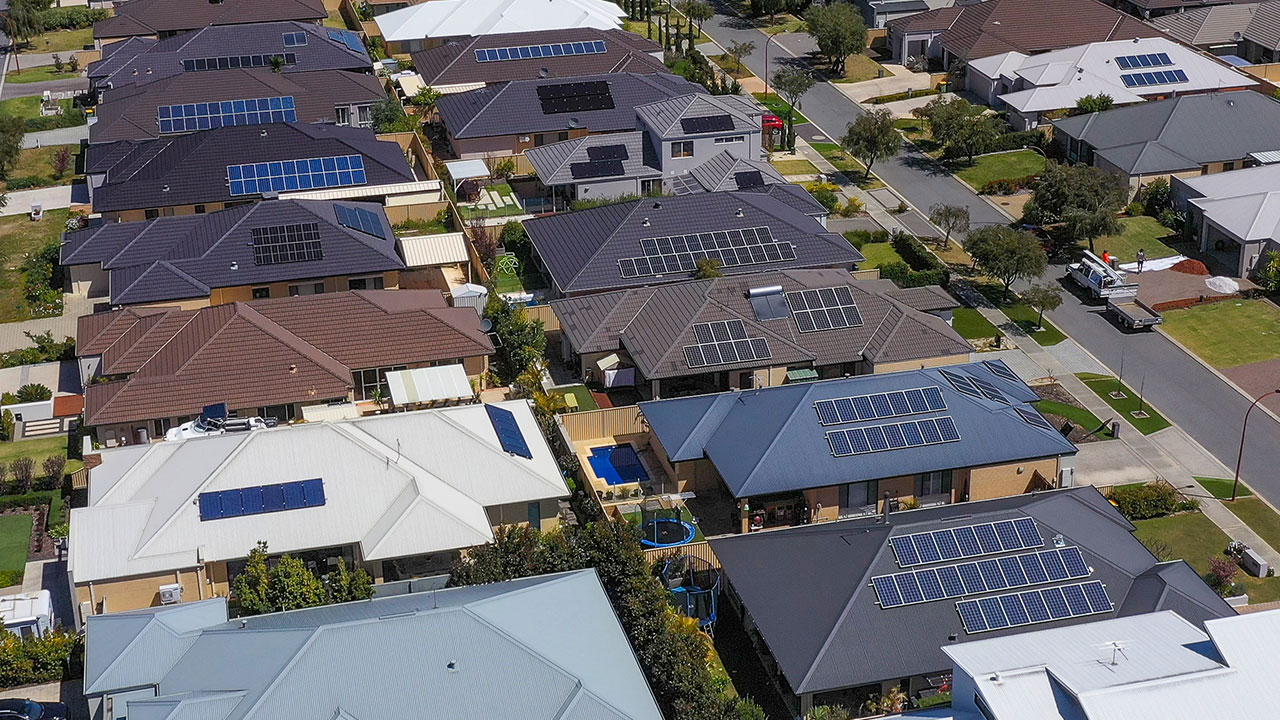 Aerial view of a houses in a suburban street which have solar panels installed on the roof