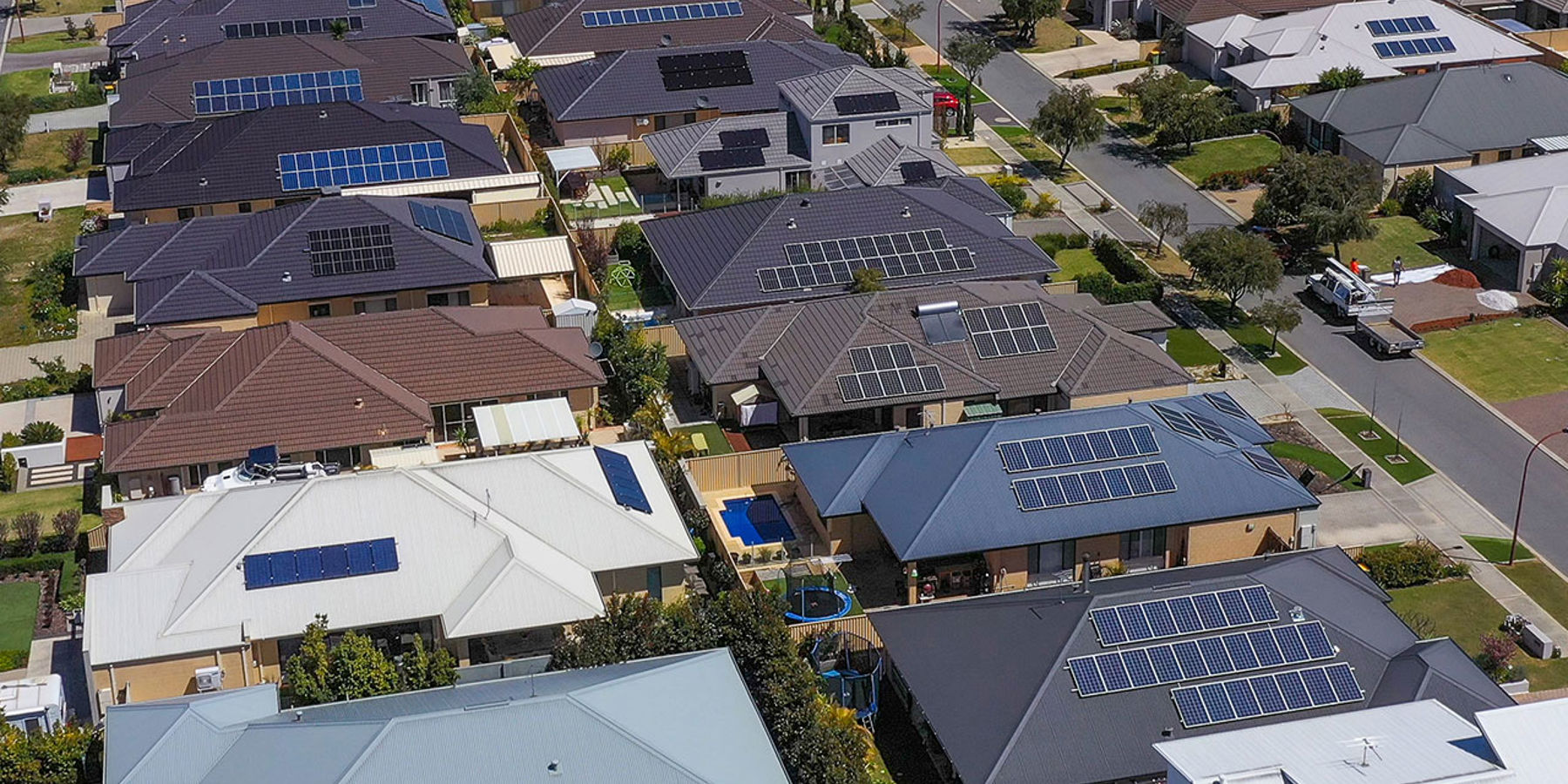 Aerial view of a houses in a suburban street which have solar panels installed on the roof