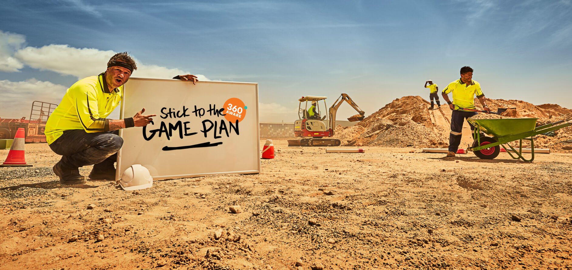 A construction worker on a building site holding a whiteboard with "Stick to the game plan" written on it.