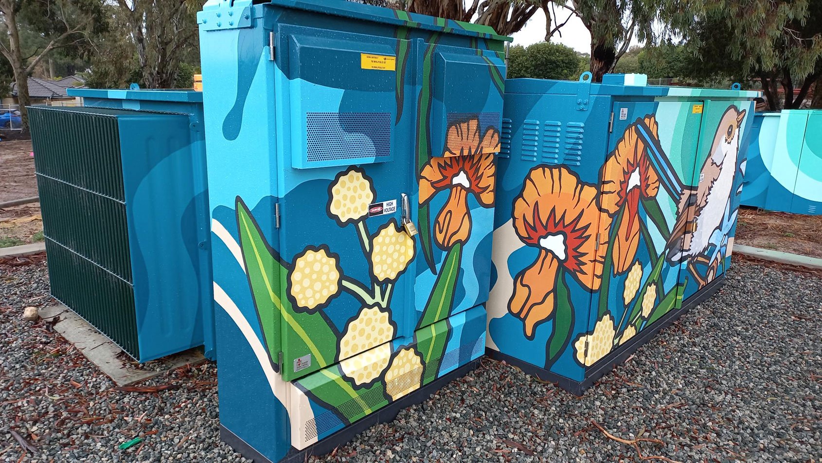 Floral and bird artwork that's been added to a ground mounted cabinet