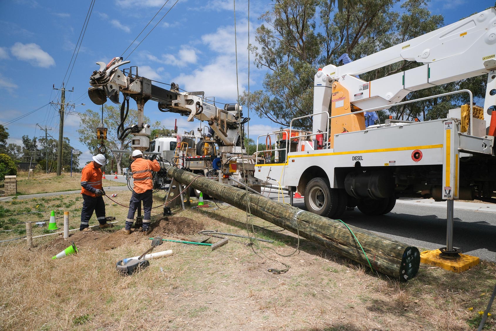 An electricity pole being replaced by a Western Power crew.
