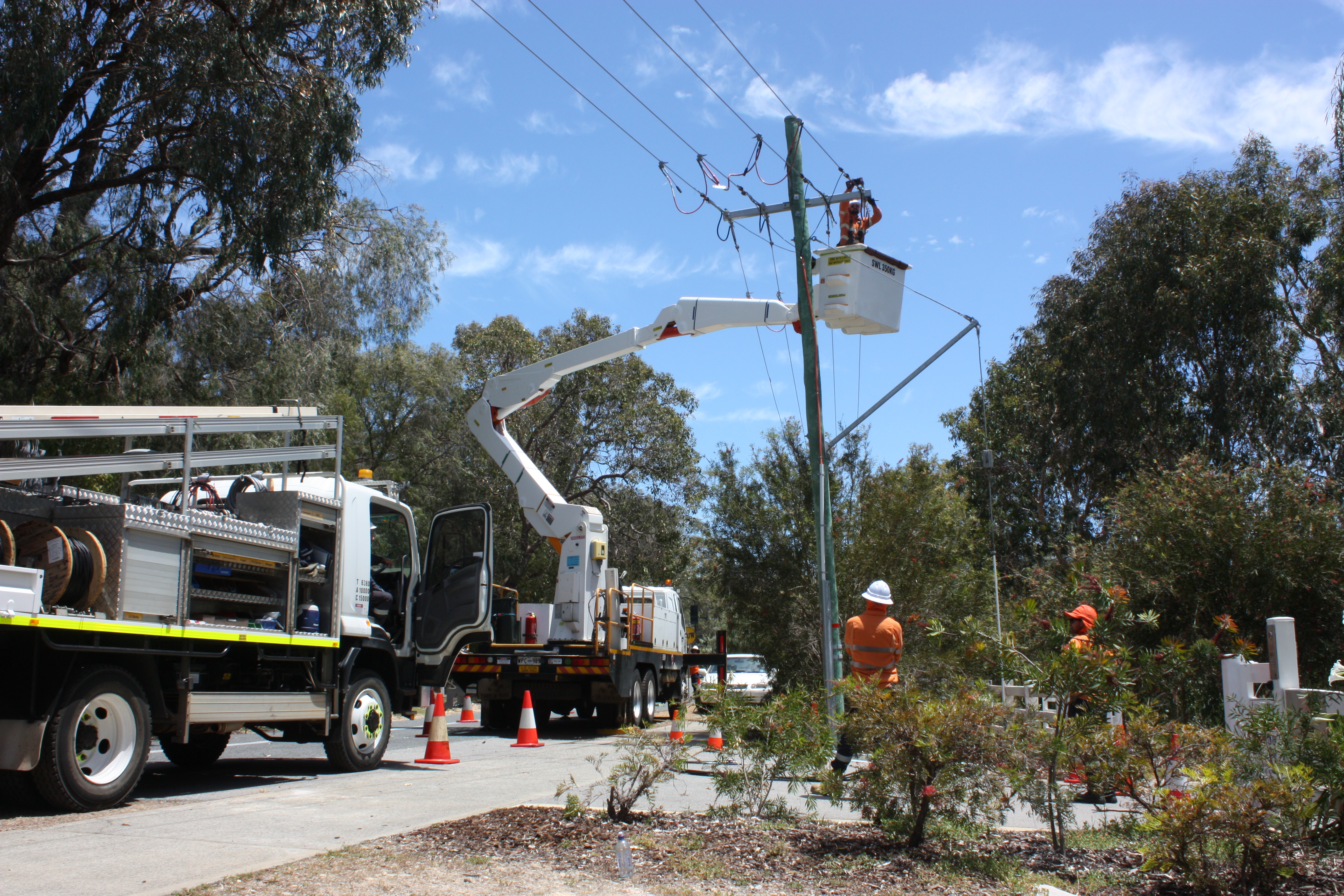 A Western Power crew conducting upgrade works using an elevated work platform in regional Western Australia.