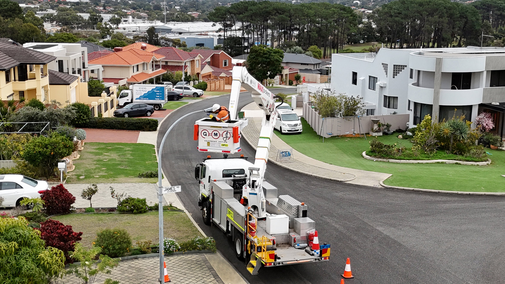 Western Power crew working on an LED streetlight in a residential suburb