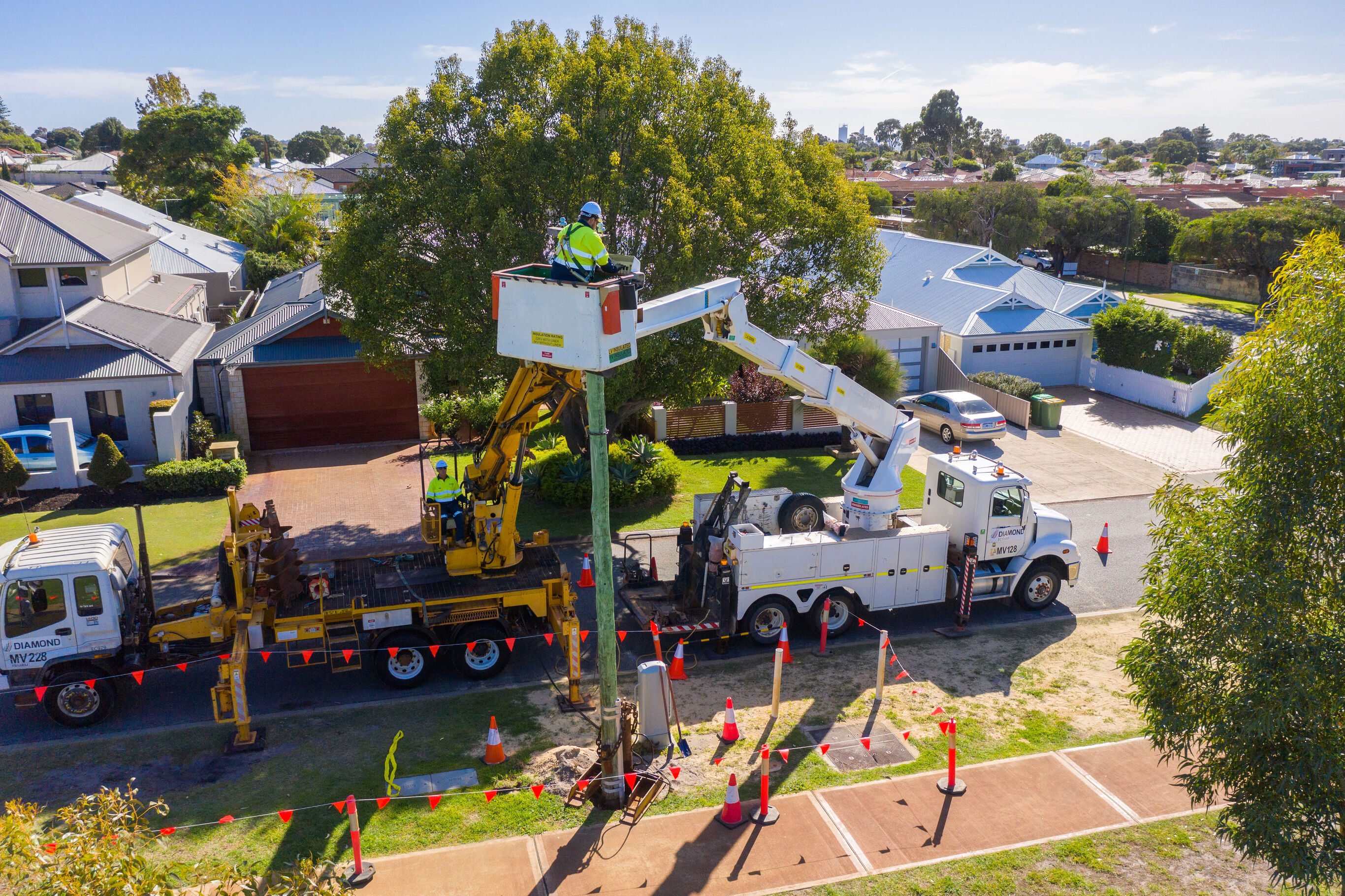 Western Power lines-person in an elevated work platform on a suburban street removing a powerpole.