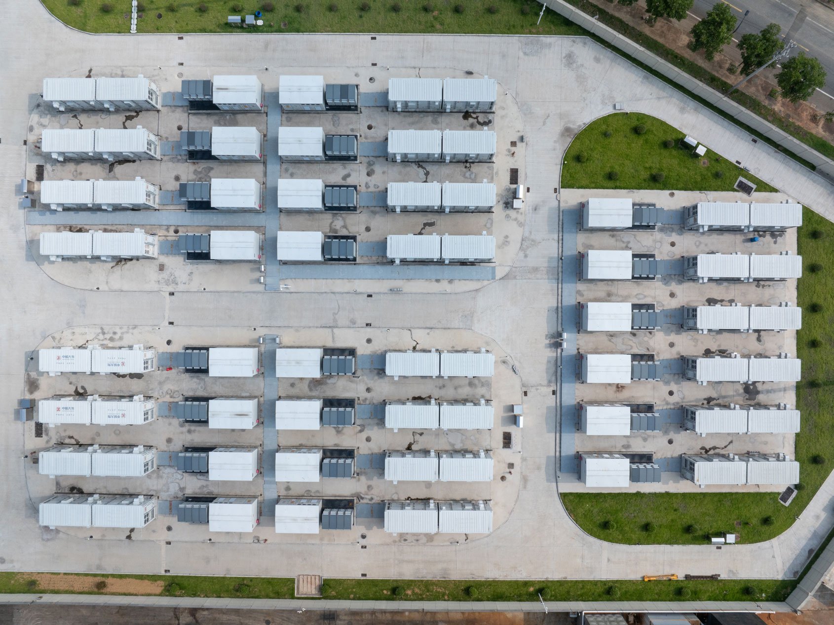 Aerial view of a grid-like layout of a battery energy storage system (BESS) facility.