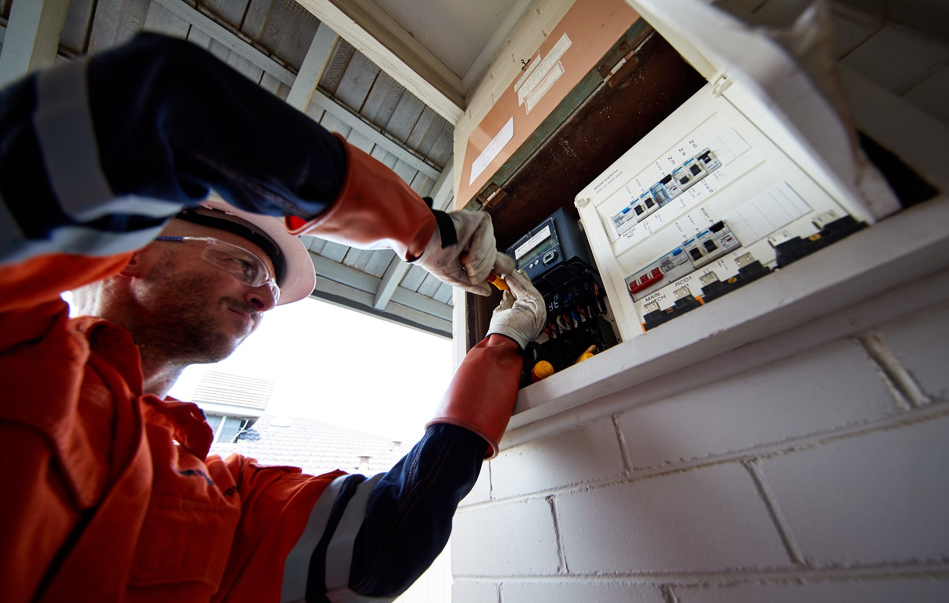 Close up of Western Power field crew installing a meter into a switchboard.