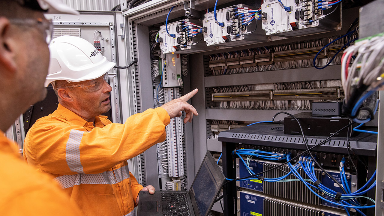 Two Western Power crew members inside the Kalbarri microgrid