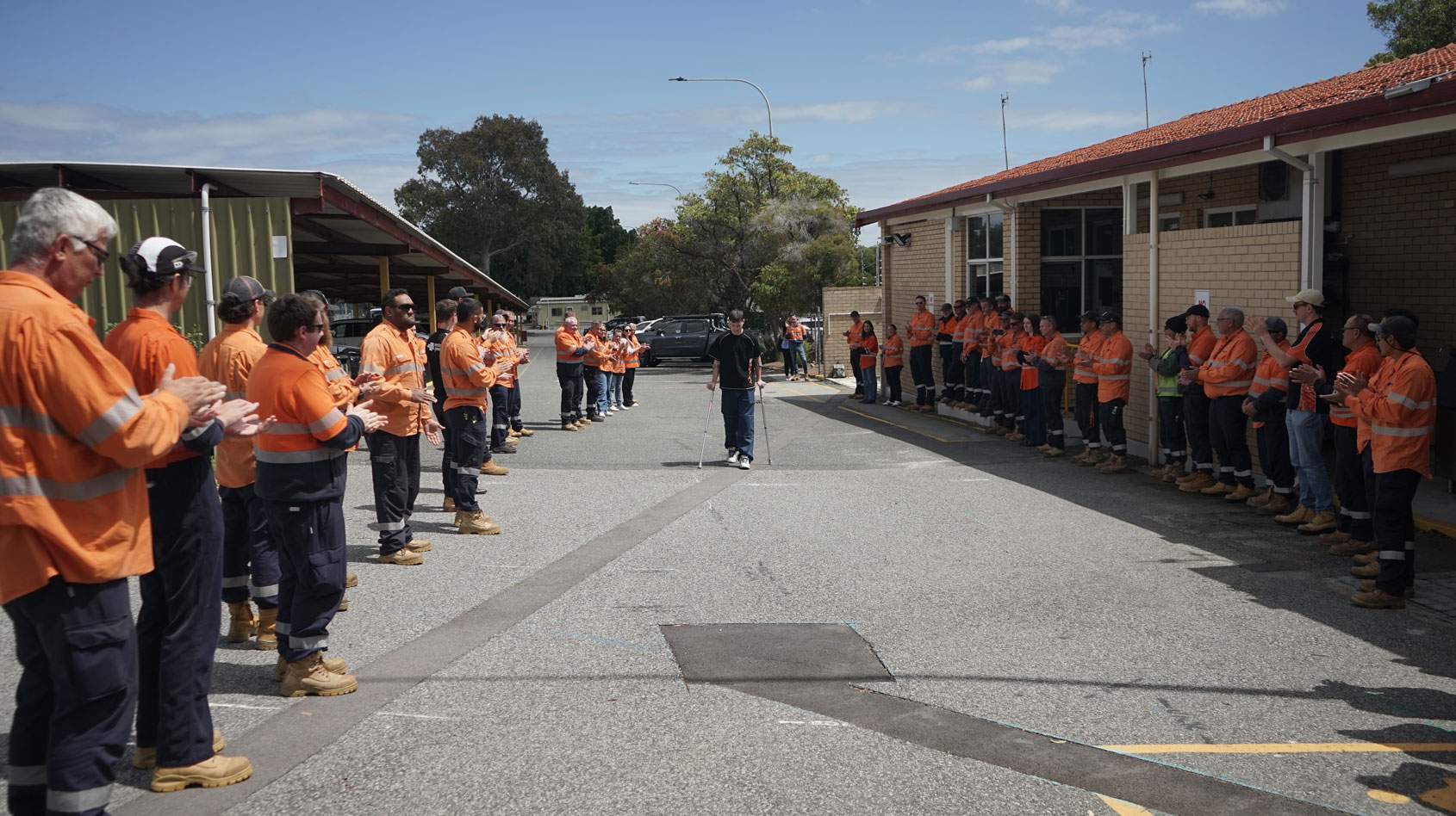Matthew Haylett walking with a guard of honour from his Western Power colleagues