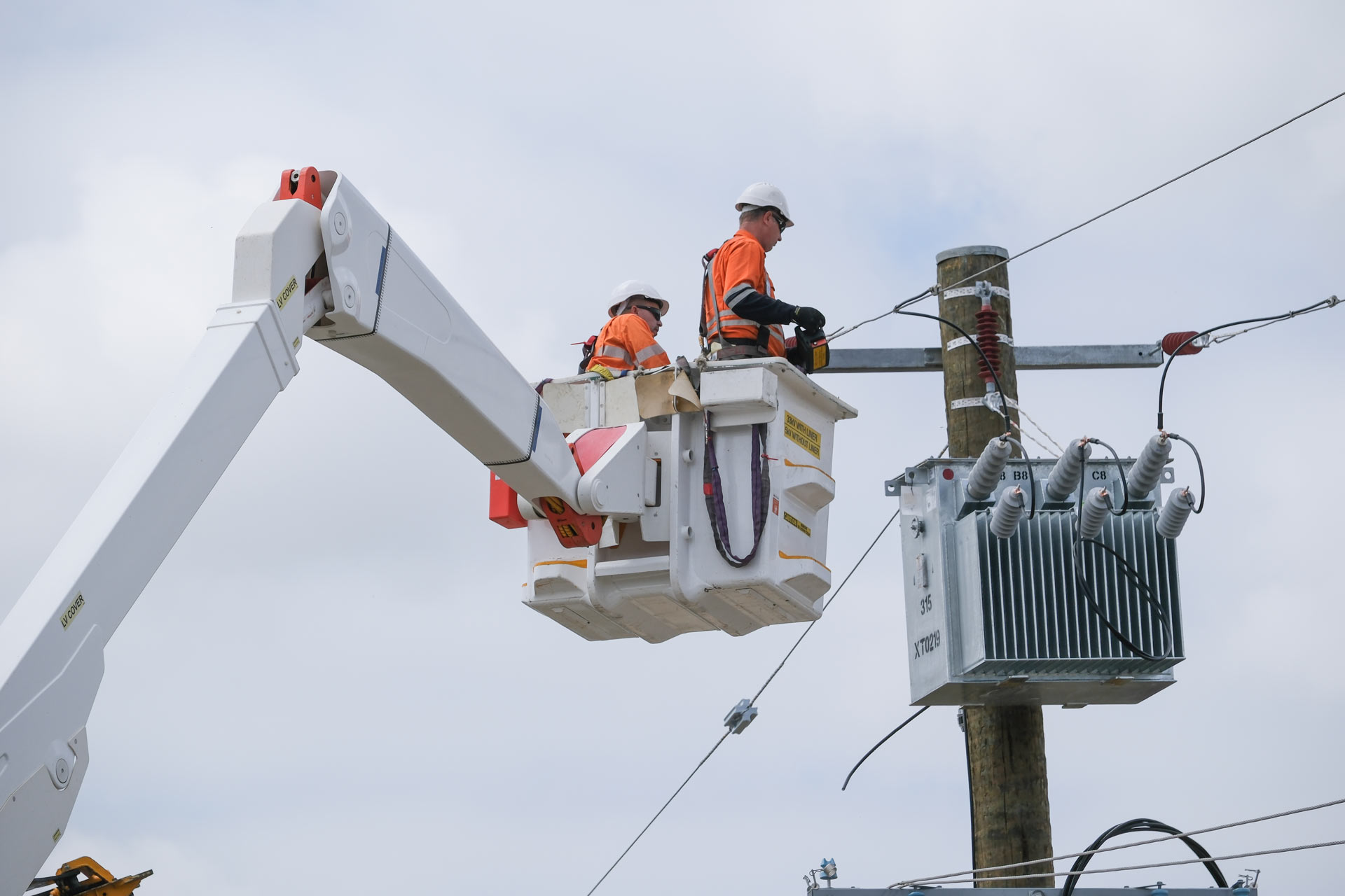 Western Power crew replacing a transformer that's attached to a pole