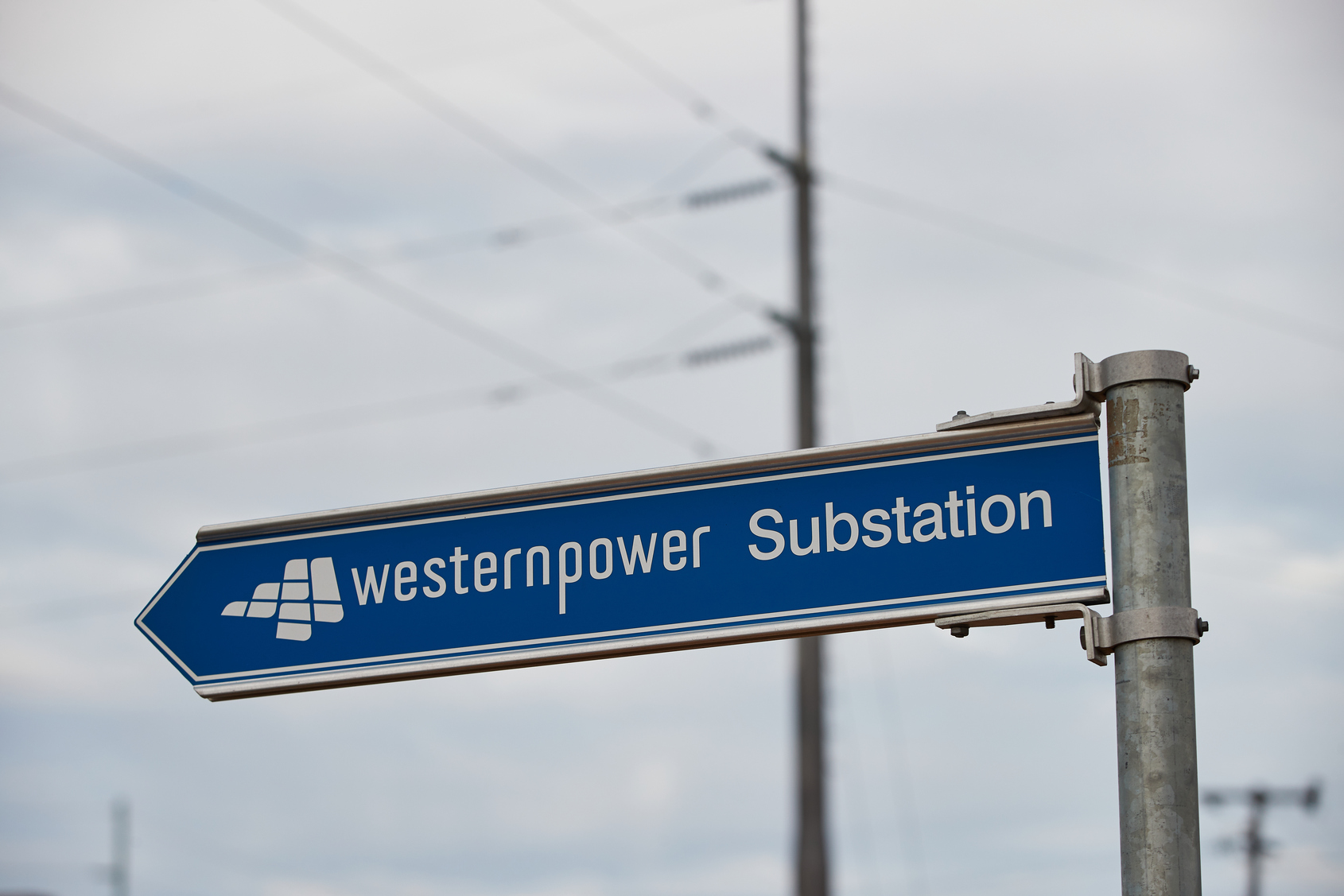 Western Power Substation road sign with electricity lines visible in the background