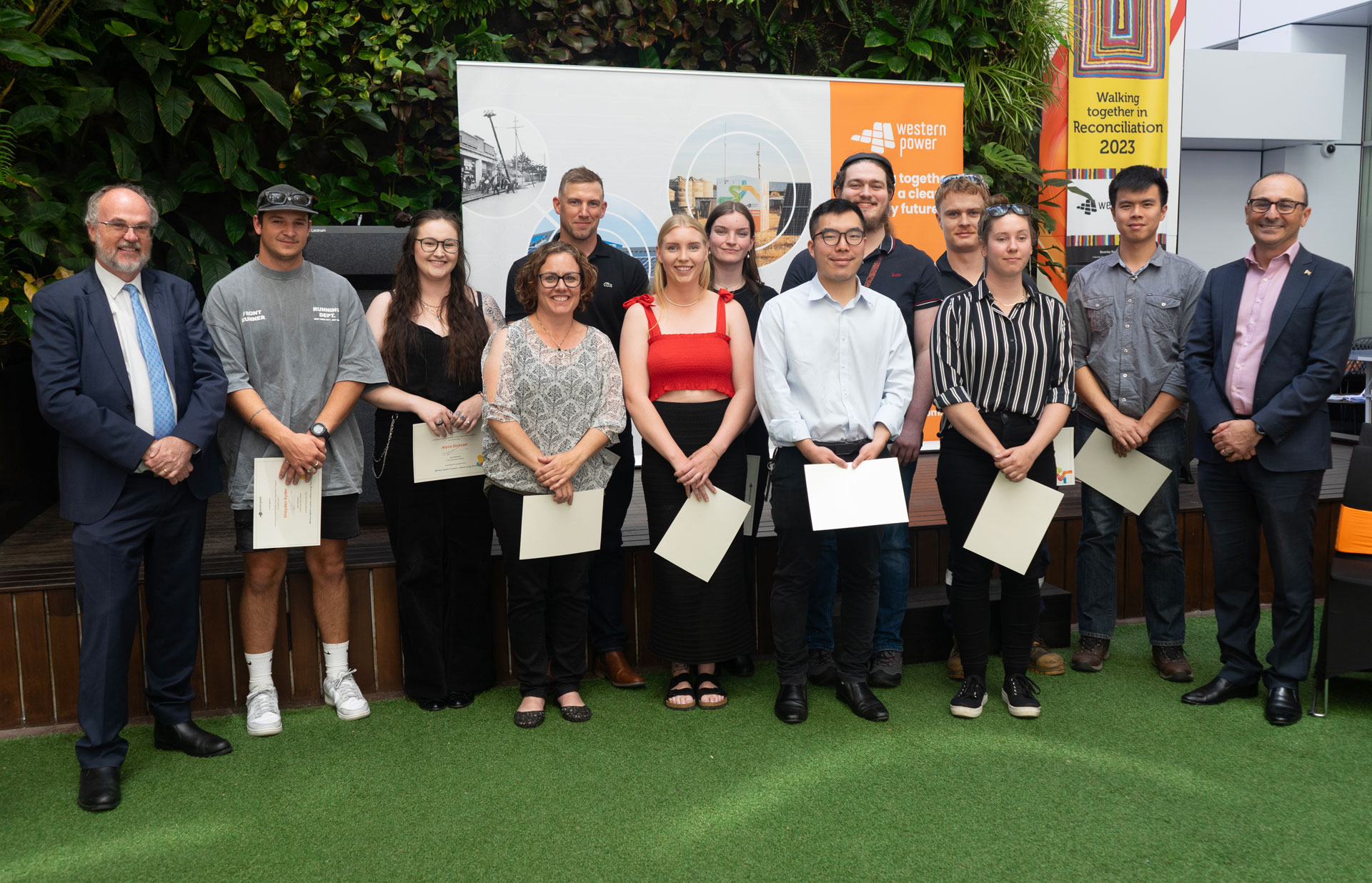 Business traineeship graduates and apprentices stood in a row alongside the Hon. Bill Johnston and Western Power CEO, Sam Barbaro