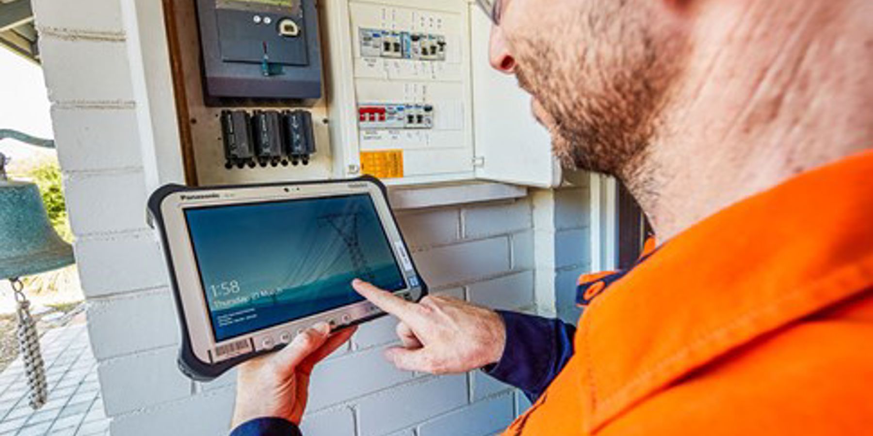 ipad and meter box with western power employee