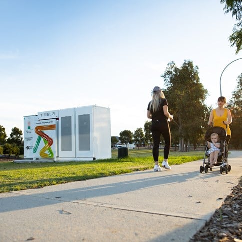 Community walking past community battery