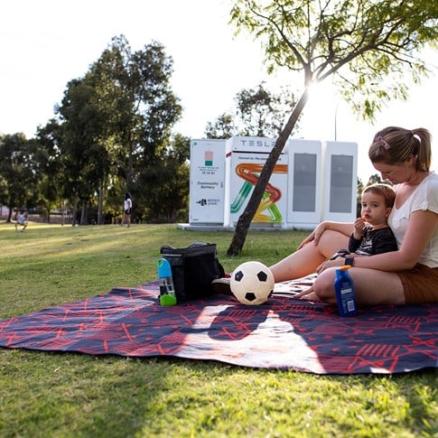 Mother and child sitting on grass at the park