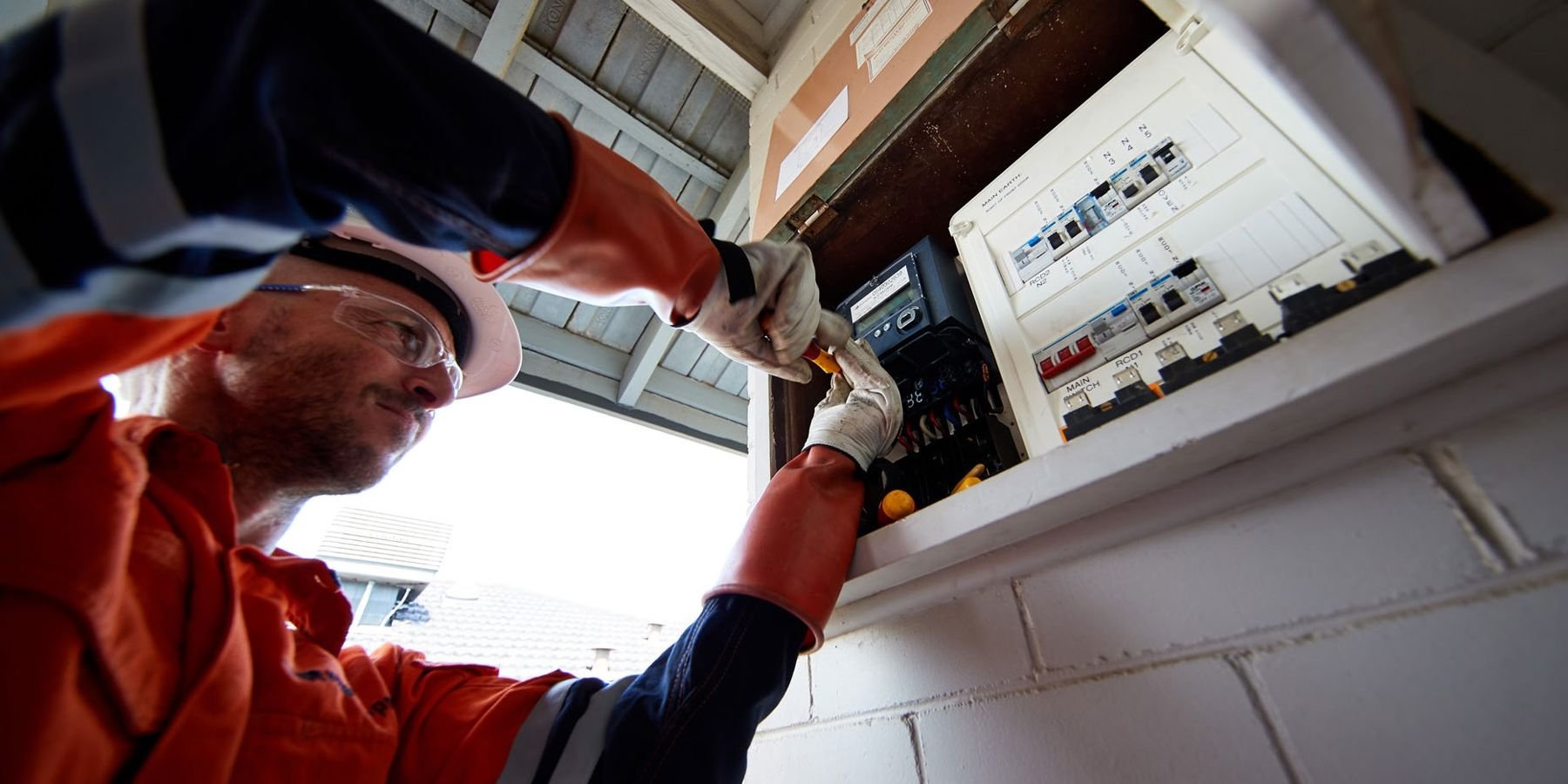 Close up of Western Power field crew installing a meter into a switchboard.