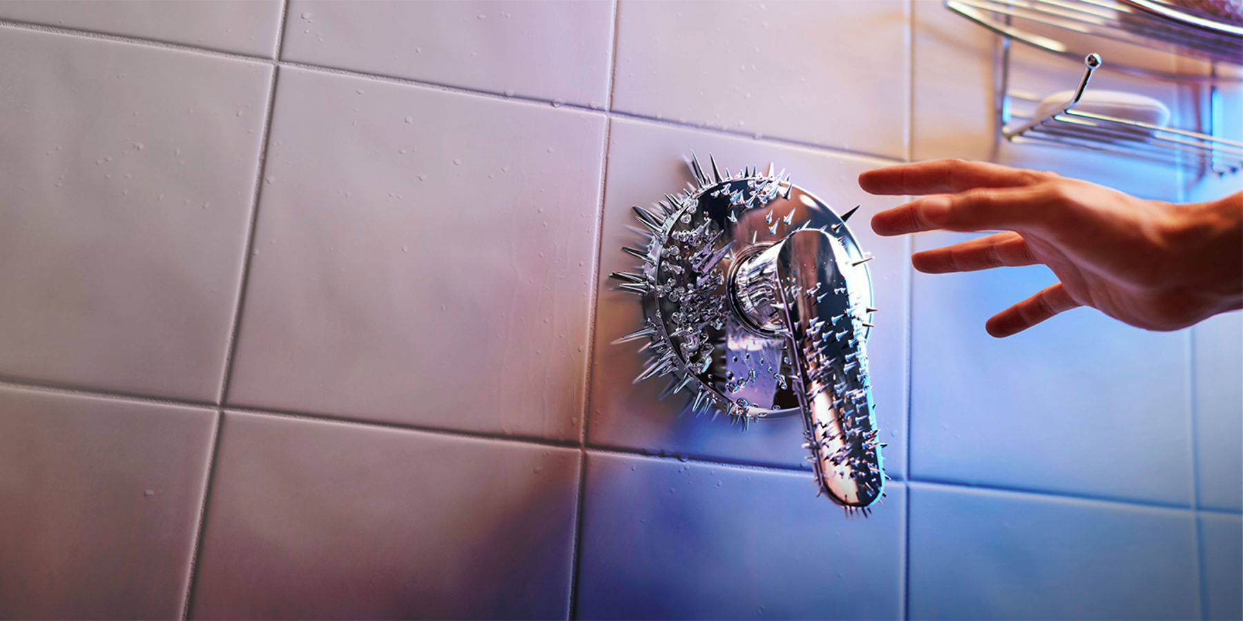 A hand about to touch a bathroom tap with spikes.